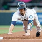 SEATTLE, WASHINGTON - JUNE 01: Tom Murphy #2 of the Seattle Mariners dives back to first base during the fourth inning against the Oakland Athletics at T-Mobile Park on June 01, 2021 in Seattle, Washington. (Photo by Steph Chambers/Getty Images)