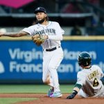 SEATTLE, WASHINGTON - JUNE 01: J.P. Crawford #3 of the Seattle Mariners throws to first base over Jed Lowrie #8 of the Oakland Athletics during the fourth inning at T-Mobile Park on June 01, 2021 in Seattle, Washington. (Photo by Steph Chambers/Getty Images)