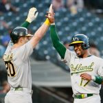 SEATTLE, WASHINGTON - JUNE 01: Mark Canha #20 and Elvis Andrus #17 of the Oakland Athletics celebrate a run against the Seattle Mariners during the fifth inning at T-Mobile Park on June 01, 2021 in Seattle, Washington. (Photo by Steph Chambers/Getty Images)