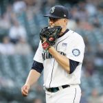 SEATTLE, WASHINGTON - JUNE 02: Chris Flexen #77 of the Seattle Mariners chews his glove after the top of the third inning against the Oakland Athletics during Lou Gehrig Day at T-Mobile Park on June 02, 2021 in Seattle, Washington. (Photo by Steph Chambers/Getty Images)