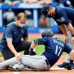CLEVELAND, OHIO - JUNE 13: Staff tend to Mitch Haniger #17 of the Seattle Mariners after an injury at-bat in the first inning during their game against the Cleveland Indians at Progressive Field on June 13, 2021 in Cleveland, Ohio. (Photo by Emilee Chinn/Getty Images)