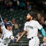SEATTLE, WASHINGTON - JUNE 14: Ty France #23 high fives J.P. Crawford #3 of the Seattle Mariners after Crawford scored a run against the Minnesota Twins during the third inning at T-Mobile Park on June 14, 2021 in Seattle, Washington. (Photo by Steph Chambers/Getty Images)