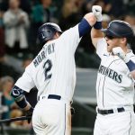 SEATTLE, WASHINGTON - JUNE 14: Tom Murphy #2 and Jake Bauers #5 of the Seattle Mariners react after a home run by Bauers during the eighth inning against the Minnesota Twins at T-Mobile Park on June 14, 2021 in Seattle, Washington. (Photo by Steph Chambers/Getty Images)