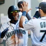 SEATTLE, WASHINGTON - JUNE 15: Shed Long Jr. #4 of the Seattle Mariners celebrates in the dugout after scoring a run during the fourth inning against the Minnesota Twins at T-Mobile Park on June 15, 2021 in Seattle, Washington. (Photo by Steph Chambers/Getty Images)