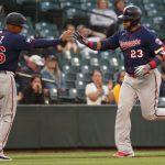 SEATTLE, WASHINGTON - JUNE 16: Nelson Cruz #23 high fives third base coach Tony Diaz #46 of the Minnesota Twins after hitting a three-run home run during the fifth inning against the Seattle Mariners at T-Mobile Park on June 16, 2021 in Seattle, Washington. (Photo by Abbie Parr/Getty Images)