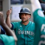 SEATTLE, WASHINGTON - JUNE 18: Kyle Seager #15 of the Seattle Mariners is congratulated by teammates after scoring in the first inning of the game against the Tampa Bay Rays at T-Mobile Park on June 18, 2021 in Seattle, Washington. (Photo by Alika Jenner/Getty Images)