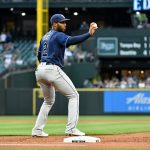 SEATTLE, WASHINGTON - JUNE 18: Yandy Diaz #2 of the Tampa Bay Rays shows the ball to the first base umpire during the game against the Seattle Mariners at T-Mobile Park on June 18, 2021 in Seattle, Washington. (Photo by Alika Jenner/Getty Images)