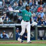 SEATTLE, WASHINGTON - JUNE 18: Shed Long Jr. #4 of the Seattle Mariners points his bat to the home dugout during the game against the Tampa Bay Rays at T-Mobile Park on June 18, 2021 in Seattle, Washington. (Photo by Alika Jenner/Getty Images)