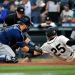 SEATTLE, WASHINGTON - JUNE 19: Mike Zunino #10 of the Tampa Bay Rays tags Dylan Moore #25 of the Seattle Mariners at the plate during the game at T-Mobile Park on June 19, 2021 in Seattle, Washington. (Photo by Alika Jenner/Getty Images)