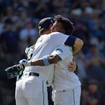 SEATTLE, WASHINGTON - JUNE 20: Shed Long Jr. #4 and manager Scott Servais #9 of the Seattle Mariners hug after his game winning grand slam against the Tampa Bay Rays at T-Mobile Park on June 20, 2021 in Seattle, Washington. The Seattle Mariners beat the Tampa Bay Rays 6-2 in extra innings. (Photo by Alika Jenner/Getty Images)