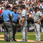 CHICAGO, ILLINOIS - JUNE 27: Umpires Phil Cuzzi #10 and Brian Gorman #9 talk to manager Scott Servais #9 before ejecting Hector Santiago #57 of the Seattle Mariners from the game after finding a substance on his glove in the fifth inning against the Chicago White Sox at Guaranteed Rate Field on June 27, 2021 in Chicago, Illinois.  Today's game is a continuation from yesterday, which was suspended due to inclement weather. (Photo by Quinn Harris/Getty Images)