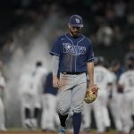 Tampa Bay Rays second baseman Brandon Lowe walks off the field as the Seattle Mariners celebrate after Kyle Seager drove in the winning run with a single in the ninth inning of a baseball game Thursday, June 17, 2021, in Seattle. The Mariners won 6-5. (AP Photo/Ted S. Warren)