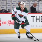 GLENDALE, ARIZONA - DECEMBER 19: Carson Soucy #21 of the Minnesota Wild skates with the puck against the Arizona Coyotes during the second period of the NHL game at Gila River Arena on December 19, 2019 in Glendale, Arizona. (Photo by Christian Petersen/Getty Images)