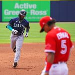 BUFFALO, NY - JULY 1: Shed Long Jr. #4 of the Seattle Mariners runs the bases after hitting a two-run home run during the third inning as Santiago Espinal #5 of the Toronto Blue Jays looks down at Sahlen Field on July 1, 2021 in Buffalo, New York. (Photo by Kevin Hoffman/Getty Images)