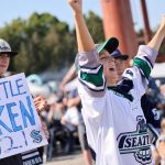 SEATTLE, WA - JULY 21: Jennifer Lang and her sons, including Jessie Lang (R), applaud as the first picks are made at the Seattle Kraken 2021 NHL expansion draft at Gas Works Park on July 21, 2021 in Seattle, Washington. Thousands of free tickets were available to fans to attend this live broadcast event on ESPN2 to watch the Kraken make 30 selections to build their first roster in franchise history. (Photo by Karen Ducey/Getty Images)
