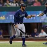 ARLINGTON, TX - JULY 30: Abraham Toro #13 of the Seattle Mariners scores and is congratulated by J.P. Crawford #3 during the second inning of a baseball game against the Texas Rangers at Globe Life Field on July 30, 2021 in Arlington, Texas. (Photo by Andy Jacobsohn/Getty Images)