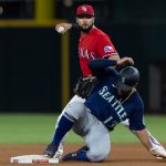ARLINGTON, TX - JULY 30: Shortstop Isiah Kiner-Falefa #9 of the Texas Rangers tries to make a play after a force out on Abraham Toro #13 of the Seattle Mariners during the seventh inning of a baseball game at Globe Life Field on July 30, 2021 in Arlington, Texas. (Photo by Andy Jacobsohn/Getty Images)