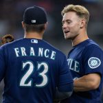 ARLINGTON, TX - JULY 30: Jarred Kelenic #10 of the Seattle Mariners speaks with Ty France #23 before the ninth inning of a baseball game at Globe Life Field on July 30, 2021 in Arlington, Texas. (Photo by Andy Jacobsohn/Getty Images)
