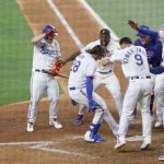 ARLINGTON, TX - JULY 31: Jonah Heim #28 of the Texas Rangers celebrates with teammates after hitting a two -run walk-off home run to defeat Seattle Mariners 5-4 in ten innings at Globe Life Field on July 31, 2021 in Arlington, Texas. 
(Photo by Ron Jenkins/Getty Images)