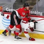 CHICAGO, ILLINOIS - FEBRUARY 02: Nikita Zadorov #16 of the Chicago Blackhawks takes down Morgan Geekie #67 of the Carolina Hurricanes along the boards at the United Center on February 02, 2021 in Chicago, Illinois. (Photo by Jonathan Daniel/Getty Images)