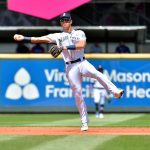 SEATTLE, WASHINGTON - JULY 04: Dylan Moore #25 of the Seattle Mariners makes a throw to first base during the second inning of the game against the Texas Rangers at T-Mobile Park on July 04, 2021 in Seattle, Washington. (Photo by Alika Jenner/Getty Images)
