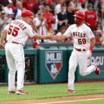 ANAHEIM, CALIFORNIA - JULY 17: Jack Mayfield #59 of the Los Angeles Angels celebrates his home run with third base coach Brian Butterfield #55 during the fourth inning against the Seattle Mariners at Angel Stadium of Anaheim on July 17, 2021 in Anaheim, California. (Photo by Katelyn Mulcahy/Getty Images)