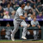 DENVER, COLORADO - JULY 20: Dylan Moore #25 of the Seattle Mariners hits a 2 RBI home run against the Colorado Rockies in the sixth inning at Coors Field on July 20, 2021 in Denver, Colorado. (Photo by Matthew Stockman/Getty Images)