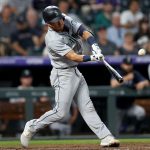 DENVER, COLORADO - JULY 20: Dylan Moore #25 of the Seattle Mariners hits a 2 RBI home run against the Colorado Rockies in the sixth inning at Coors Field on July 20, 2021 in Denver, Colorado. (Photo by Matthew Stockman/Getty Images)