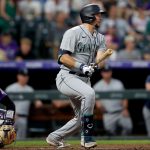 DENVER, COLORADO - JULY 20: Cal Raleigh #29 of the Seattle Mariners hits a 2 RBI home double against the Colorado Rockies in the sixth inning at Coors Field on July 20, 2021 in Denver, Colorado. (Photo by Matthew Stockman/Getty Images)