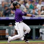 DENVER, COLORADO - JULY 20: Connor Joe #9 of the Colorado Rockies hits a 2 RBI home run against the Seattle Mariners in the fifth inning at Coors Field on July 20, 2021 in Denver, Colorado. (Photo by Matthew Stockman/Getty Images)