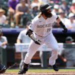 DENVER, COLORADO - JULY 21: Charlie Blackmon #19 of the Colorado Rockies hits a RBI single against the Seattle Mariners in the first inning at Coors Field on July 21, 2021 in Denver, Colorado. (Photo by Matthew Stockman/Getty Images)