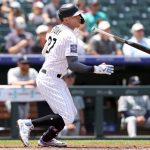 DENVER, COLORADO - JULY 21: Trevor Story #27 of the Colorado Rockies hits a single against the Seattle Mariners in the first inning at Coors Field on July 21, 2021 in Denver, Colorado. (Photo by Matthew Stockman/Getty Images)