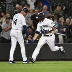 SEATTLE, WASHINGTON - JULY 22: Tom Murphy #2 of the Seattle Mariners shakes hands with Manny Acta #14 after hitting a home run during the seventh inning of the game against the Oakland Athletics at T-Mobile Park on July 22, 2021 in Seattle, Washington. (Photo by Alika Jenner/Getty Images)