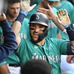 SEATTLE, WASHINGTON - JULY 23: Luis Torrens #22 of the Seattle Mariners celebrates with teammates after hitting a home run during the second inning of the game against the Oakland Athletics at T-Mobile Park on July 23, 2021 in Seattle, Washington. (Photo by Alika Jenner/Getty Images)