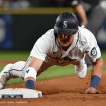 SEATTLE, WASHINGTON - JULY 24: Jake Bauers #5 of the Seattle Mariners dives safely back to first base during the fifth inning of the game against the Oakland Athletics at T-Mobile Park on July 24, 2021 in Seattle, Washington. (Photo by Alika Jenner/Getty Images)