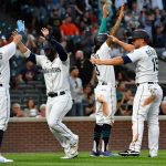 SEATTLE, WASHINGTON - JULY 26: (L-R) Luis Torrens #22, Ty France #23, J.P. Crawford #3, and Kyle Seager #15 of the Seattle Mariners celebrate after Cal Raleigh's three run scoring double in the fourth inning of the game against the Houston Astros at T-Mobile Park on July 26, 2021 in Seattle, Washington. (Photo by Alika Jenner/Getty Images)