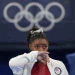 
              Simone Biles, of the United States, watches gymnasts perform at the 2020 Summer Olympics, Tuesday, July 27, 2021, in Tokyo. Biles says she wasn't in right 'headspace' to compete and withdrew from gymnastics team final to protect herself. (AP Photo/Ashley Landis)
            