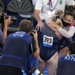 
              Sunisa Lee, of the United States, embraces teammate Jade Carey after winning the gold medal in the artistic gymnastics women's all-around final at the 2020 Summer Olympics, Thursday, July 29, 2021, in Tokyo. (AP Photo/Ashley Landis)
            