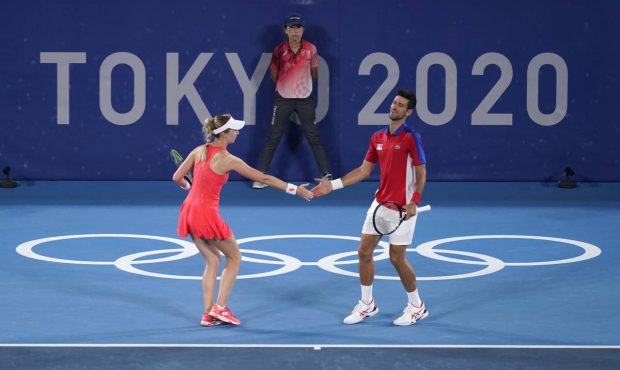 The Serbian mixed doubles team of Nina Stojanovic, left, and Novak Djokovic play during the quarter...