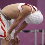 
              China's Gao Shiyan reacts to his team's loss to Japan during a men's 3-on-3 basketball game at the 2020 Summer Olympics, Tuesday, July 27, 2021, in Tokyo, Japan. (AP Photo/Jeff Roberson)
            