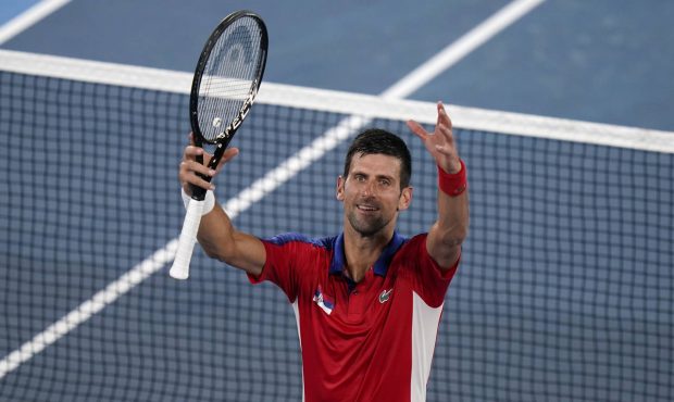 Novak Djokovic, of Serbia, celebrates after defeating Kei Nishikori, of Japan, during the quarterfi...