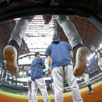 ARLINGTON, TX - AUGUST 1: Shed Long Jr. #4 of the Seattle Mariners dangles his cleats over the photographers well before the Seattle Mariners play the Texas Rangers at Globe Life Field on August 1, 2021 in Arlington, Texas. 
(Photo by Ron Jenkins/Getty Images)