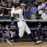 NEW YORK, NY - AUGUST 6: Aaron Judge #99 of the New York Yankees hits a run scoring sacrifice fly against the Seattle Mariners during the eighth inning at Yankee Stadium on August 6, 2021 in New York City. (Photo by Adam Hunger/Getty Images)