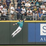 SEATTLE, WA -  AUGUST 13: Rightfielder Mitch Haniger #17 of the Seattle Mariners jumps to make a catch for an out on a ball hit by Vladimir Guerrero #27 of the Toronto Blue Jays during the first inning of a game at T-Mobile Park on August 13, 2021 in Seattle, Washington. (Photo by Stephen Brashear/Getty Images)