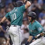SEATTLE, WA -  AUGUST 13: Tom Murphy #2 and Jarred Kelenic #10 of the Seattle Mariners celebrate after Murphy hit a two-run home run off of starting pitcher Robbie Ray #38 of the Toronto Blue Jays during the third inning of a game at T-Mobile Park on August 13, 2021 in Seattle, Washington. (Photo by Stephen Brashear/Getty Images)