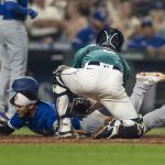 SEATTLE, WA -  AUGUST 13: Catcher Tom Murphy #2 of the Seattle Mariners tags out Breyvic Valera #74 of the Toronto Blue Jays at home plate during the ninth inning of a game at T-Mobile Park on August 13, 2021 in Seattle, Washington. (Photo by Stephen Brashear/Getty Images)