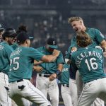 SEATTLE, WA -  AUGUST 13: Jarred Kelenic #10 of the Seattle Mariners (R) celebrates with teammates including Tom Murphy #2, Dylan Moore #25 and Drew Steckenrider #16 after a walk off walk to end a game against the Toronto Blue Jays at T-Mobile Park on August 13, 2021 in Seattle, Washington. The Mariners won 3-2. (Photo by Stephen Brashear/Getty Images)