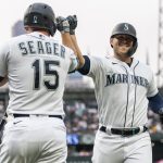 SEATTLE, WA -  AUGUST 14: Ty France #23 of the Seattle Mariners is congratulated by Kyle Seager #15 afterh hitting a two-run home run off of starting pitcher Hyun-Jin Ryu #99 of the Toronto Blue Jays that also scored Mitch Haniger #17 of the Seattle Mariners during the first inning of a game at T-Mobile Park on August 14, 2021 in Seattle, Washington. (Photo by Stephen Brashear/Getty Images)