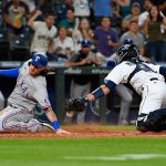 SEATTLE, WASHINGTON - AUGUST 10: Jonah Heim #28 of the Texas Rangers scores when Tom Murphy #2 of the Seattle Mariners drops the ball during the fifth inning of the game at T-Mobile Park on August 10, 2021 in Seattle, Washington. (Photo by Alika Jenner/Getty Images)