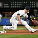 SEATTLE, WASHINGTON - AUGUST 11: Ty France #23 of the Seattle Mariners takes the throw at first base in the seventh inning against the Texas Rangers at T-Mobile Park on August 11, 2021 in Seattle, Washington. (Photo by Alika Jenner/Getty Images)